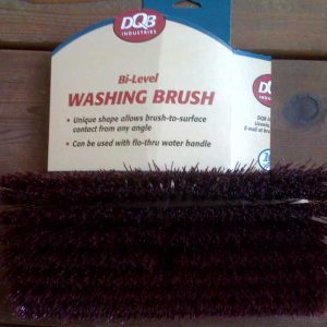 Bi-level washing brush in packaging labeled DQB Industries placed on a wooden surface.