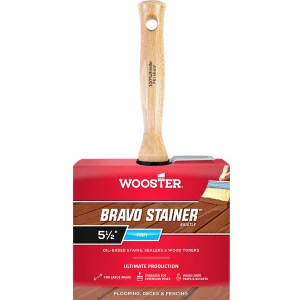 Wooden-handled brush attached to red Wooster Bravo Stainer packaging for oil-based stains.